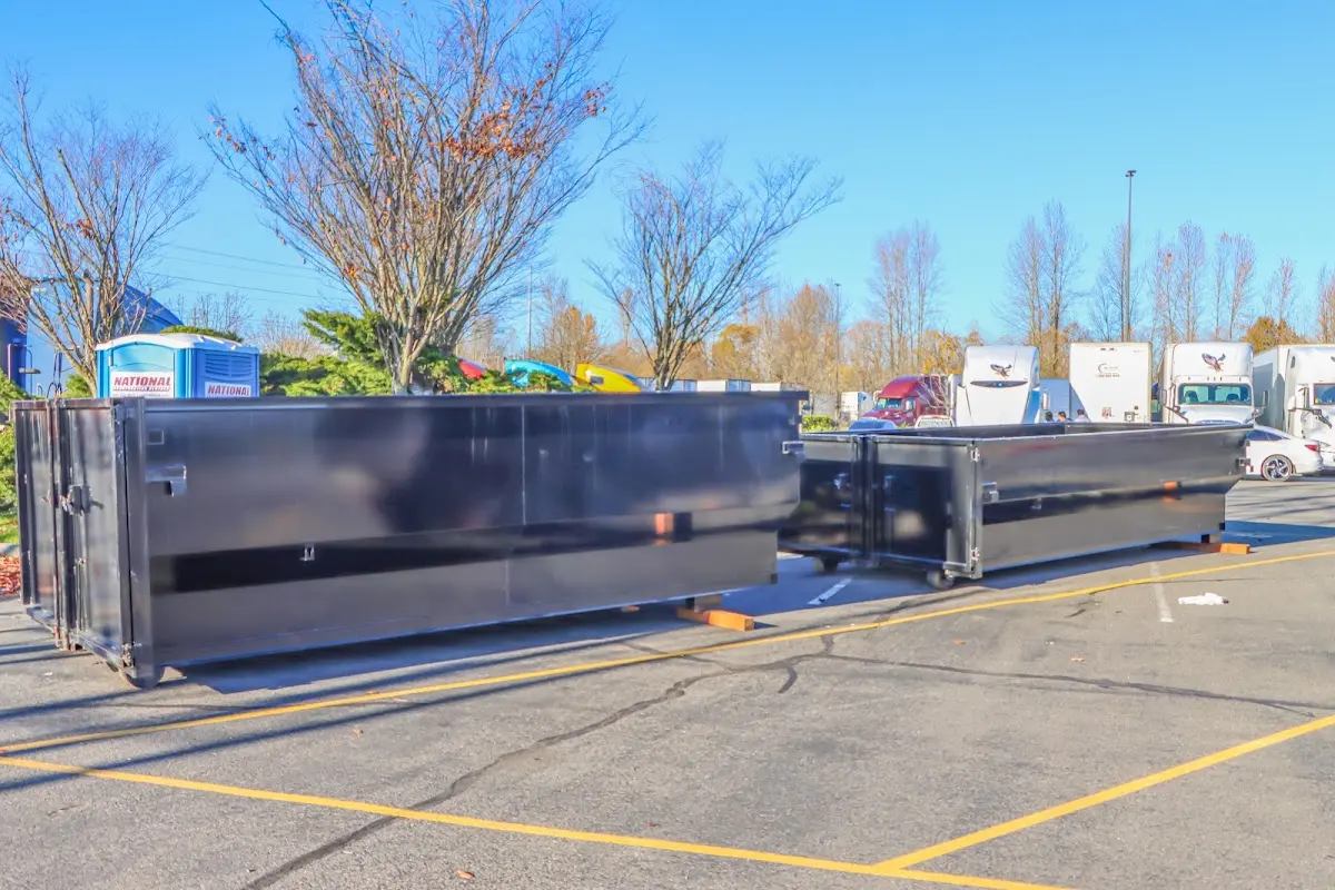 Professional dumpster rental service with roll-off container on residential driveway in Richland